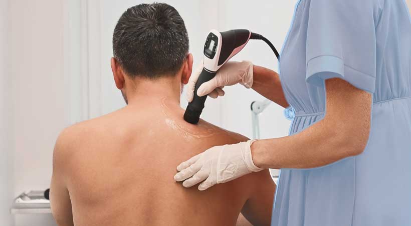 patient receiving shockwave therapy in Flower Mound for pain relief